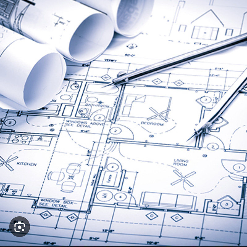 Rolled architectural blueprints and pens on top of detailed house floor plans, including kitchen, bedroom, and living room areas.
